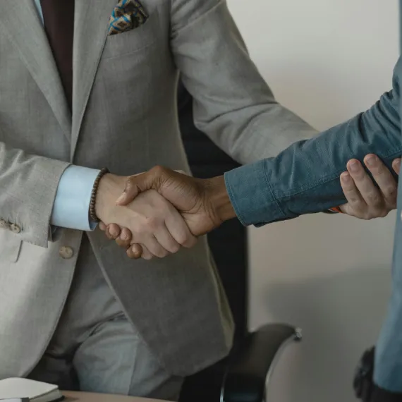 A business handshake at a Serviq client engagement